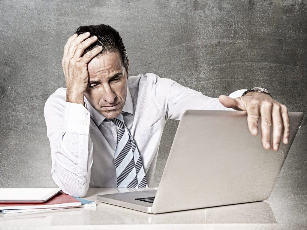 desperate senior businessman in crisis working office computer
